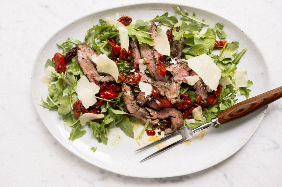 This image released by Milk Street shows a recipe for skirt steak salad with arugula and Peppadew peppers. (Milk Street via AP)