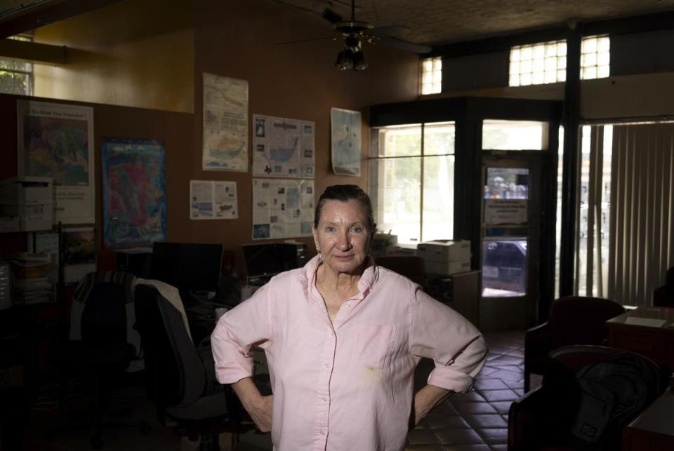 Annalisa Peace, Executive Director at the Greater Edwards Aquifer Alliance, stands among maps and workspaces at the nonprofit’s headquarters in San Antonio on June 14, 2023. “The Edwards is one of the most prolific water systems in the world,” Peace said. While Peace says the Edwards is a bounteous resource, it’s also “incredibly vulnerable to pollution.”