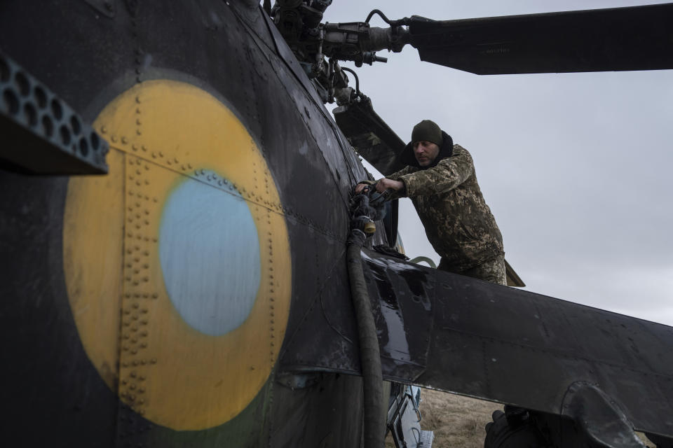 A Ukrainian serviceman refuels an Mi-24 combat helicopter between fighting with Russian troops in Donetsk region, Ukraine, Saturday, March 18, 2023. (AP Photo/Evgeniy Maloletka)