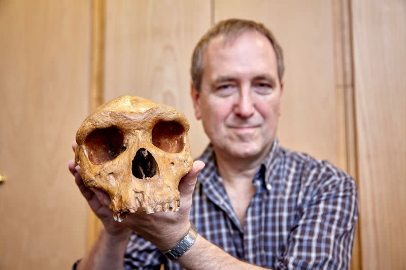 The Natural History Museum's Professor Chris Stringer is seen holding the Broken Hill skull