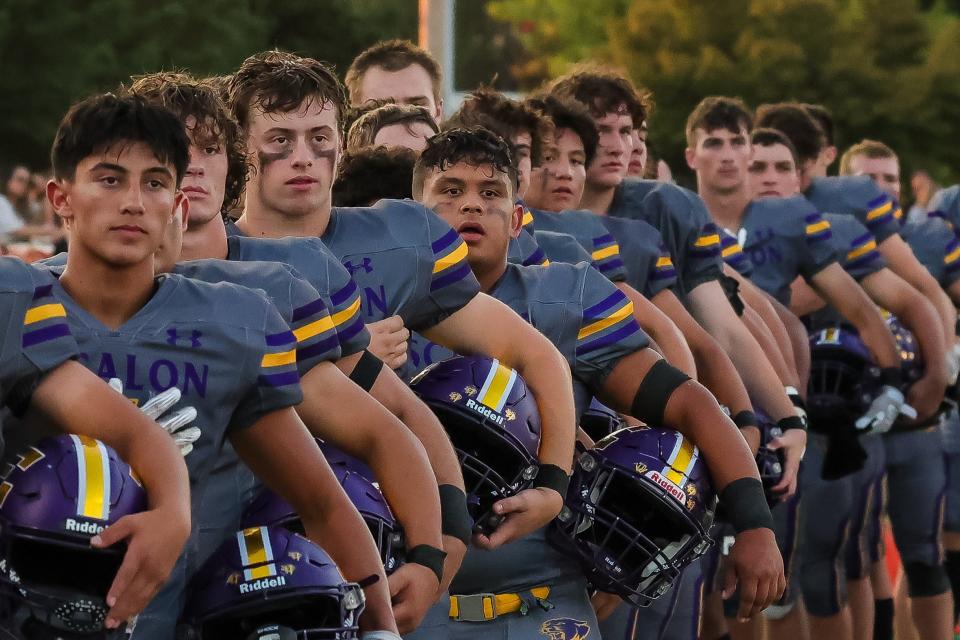 Escalon football stands for the national anthem ahead of its game against Oakdale at Oakdale High School on Sept. 15, 2023.