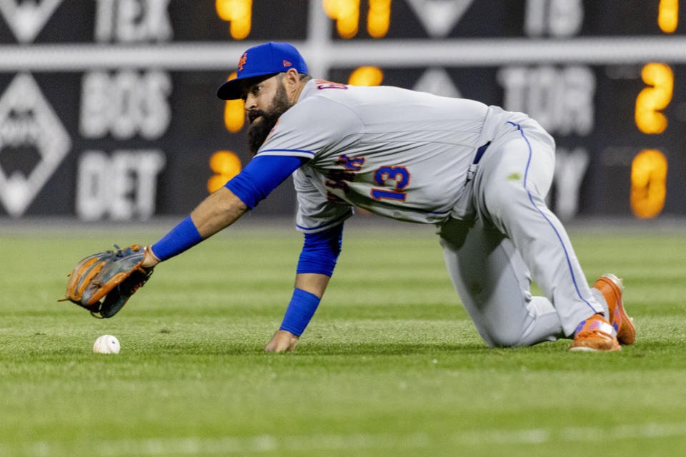 New York Mets shortstop Luis Guillorme (13) reaches for a single from Philadelphia Phillies' Didi Gregorius during the seventh inning of a baseball game, Monday, April 11, 2022, in Philadelphia. (AP Photo/Laurence Kesterson)