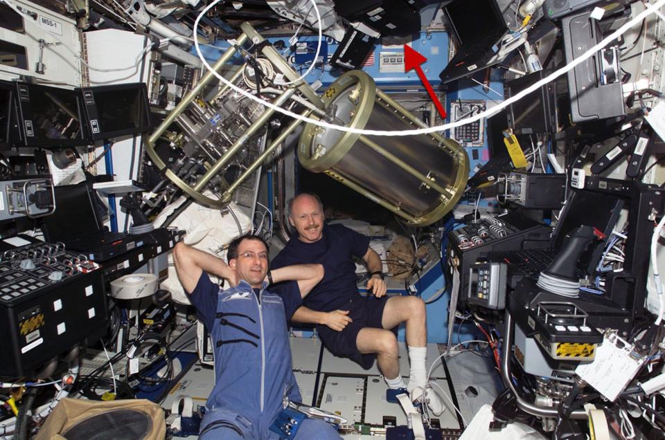 Spot the printer: An Epson 800 printer can be seen mounted on the ceiling of the space station's Destiny lab amid other equipment and astronauts Don Pettit and Ken Bowersox in March 2003. <cite>NASA</cite>