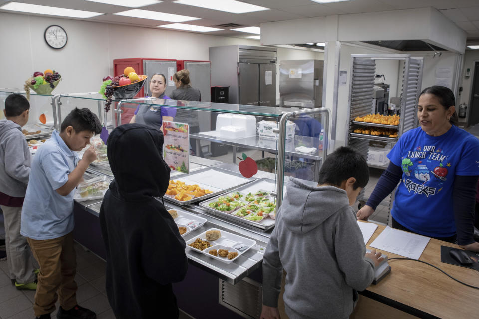 Students select their meal during lunch break in the cafeteria at V. H. Lassen Academy of Science and Nutrition in Phoenix, Tuesday, Jan. 31, 2023. (AP Photo/Alberto Mariani)