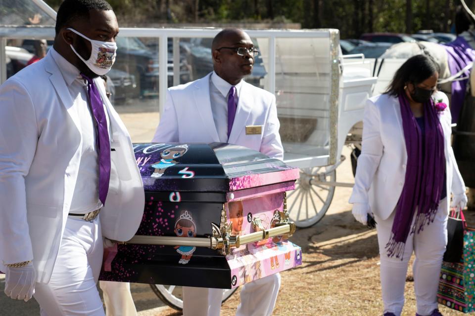 Pallbearers carry Arbrie Anthony's casket Wednesday at Hillcrest Memorial Park. It was decorated with pink and purple and images of the 8-year-old and her favorite things.