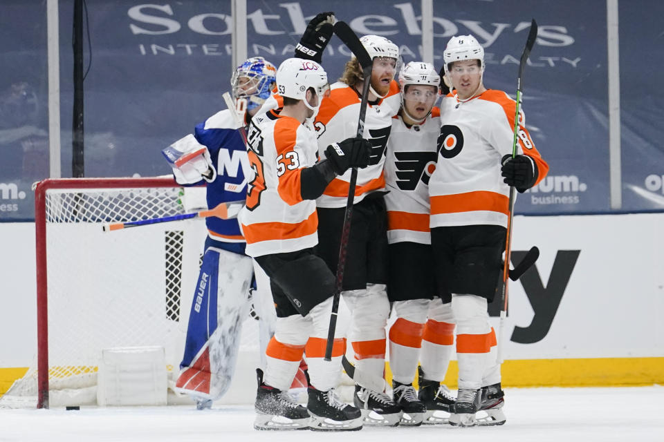 Philadelphia Flyers' Jakub Voracek, center, celebrates with teammates Travis Konecny (11), Robert Hagg (8) and Shayne Gostisbehere (53) after scoring a goal during the second period of an NHL hockey game against the New York Islanders Thursday, April 8, 2021, in Uniondale, N.Y. (AP Photo/Frank Franklin II)