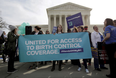 FILE PHOTO: Supporters of contraception rally before Zubik v. Burwell, an appeal brought by Christian groups demanding full exemption from the requirement to provide insurance covering contraception under the Affordable Care Act, is heard by the U.S. Supreme Court in Washington March 23, 2016. REUTERS/Joshua Roberts/File Photo