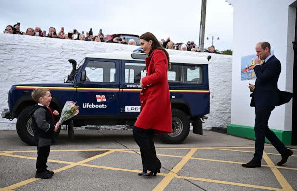 PHOTO: Prince William, Prince of Wales watches as his wife Catherine, Princess of Wales is presented with a posy of flowers by Theo Crompton during their visit to the RNLI Holyhead Lifeboat Station in Anglesey, north west Wales on Sept. 27, 2022. (Paul Ellis/POOL/AFP via Getty Images)