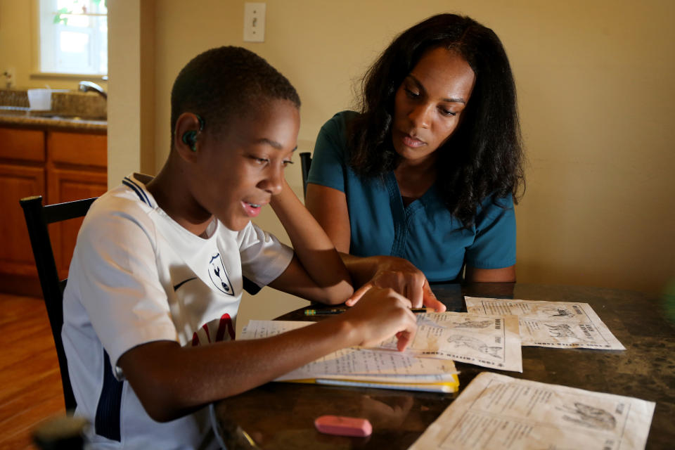 RICHMOND, CA - SEPTEMBER 11: Jasmine Porter helps her son Dontae Butler, 11, with his homework at the apartment where they live in Richmond, Calif., on Tuesday, Sept. 11, 2018. According to local realtors, homes aren't selling for as much as they did several months ago and are taking longer to sell. Porter is looking to buy a house. (Ray Chavez/Digital First Media/The Mercury News via Getty Images)