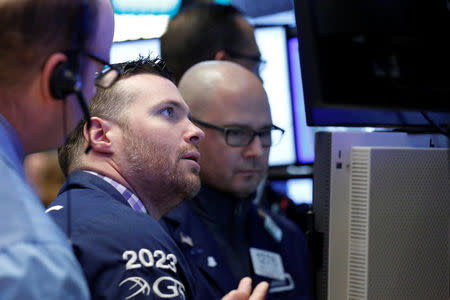 Traders work on the floor of the New York Stock Exchange (NYSE) in New York, U.S., March 6, 2017. REUTERS/Brendan McDermid