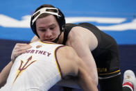 Iowa's Spencer Lee, top, takes on Arizona State's Brandon Courtney during their 125-pound match in the finals of the NCAA wrestling championships Saturday, March 20, 2021, in St. Louis. (AP Photo/Jeff Roberson)