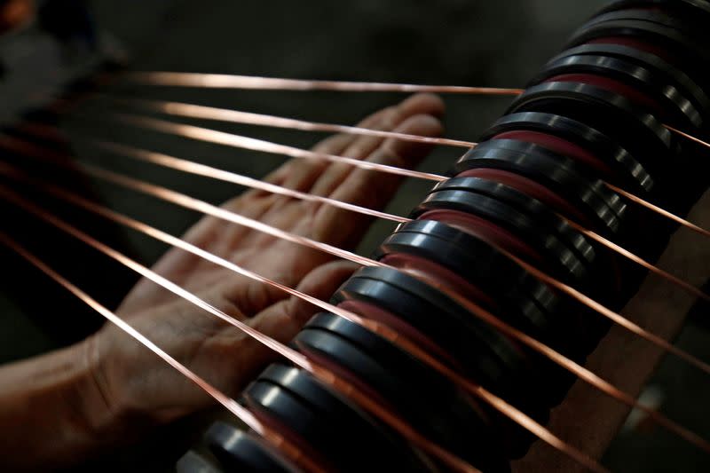 FILE PHOTO: A worker checks copper wires at Truong Phu cable factory in northern Hai Duong province, outside Hanoi