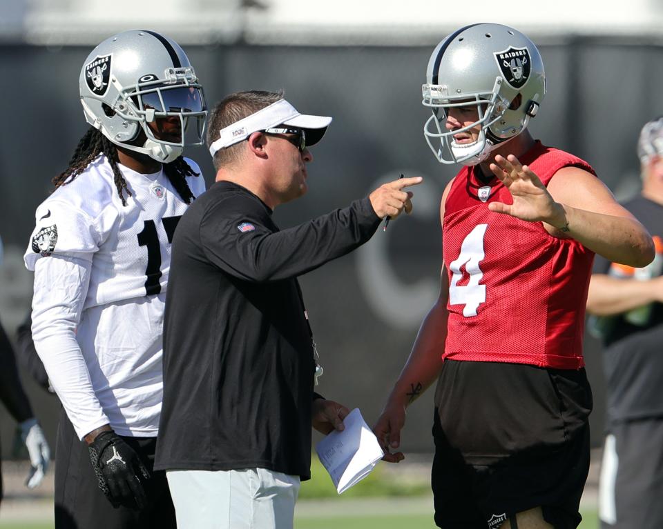 Wide receiver Davante Adams, left, head coach Josh McDaniels and quarterback Derek Carr, right, take part in practice at the Raiders training camp in Henderson, Nevada.