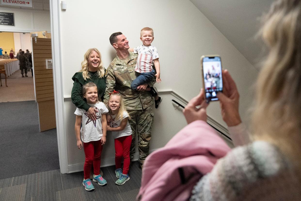 Maj. Jim Field of the Ohio Army National Guard poses with his wife, Tara; son Ethan, 4; and daughters Paige, 8, and Nora, 6, following a call to duty ceremony for deploying soldiers Friday at the Reynoldsburg Community Church.