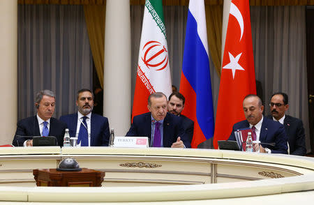 Turkish President Tayyip Erdogan speaks during a meeting with his counterparts Vladimir Putin of Russia and Hassan Rouhani of Iran in Sochi, Russia, November 22, 2017. Kayhan Ozer/Turkish Presidential Palace/Handout via REUTERS