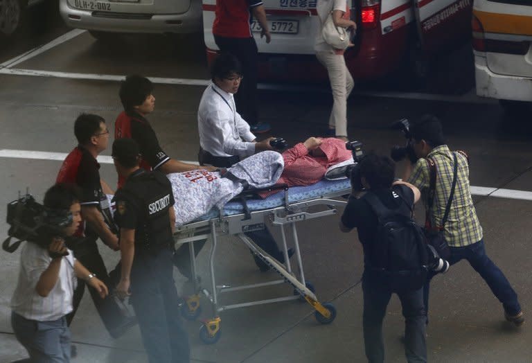 A passenger of the Asiana Airlines crash in San Francisco arrives on a stretcher at Incheon Airport, west of Seoul on July 8, 2013. Asiana Airlines has confirmed that the pilot flying the Boeing 777 was in training, raising the possibility that human error caused the deadly accident
