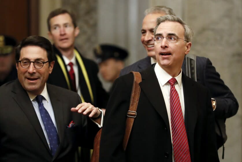 President Donald Trump's personal attorney Jay Sekulow, left, walks with White House Counsel Pat Cipollone, right, as they arrive at the Capitol in Washington during the impeachment trial of President Donald Trump on charges of abuse of power and obstruction of Congress, Friday, Jan. 24, 2020. (AP Photo/Julio Cortez)