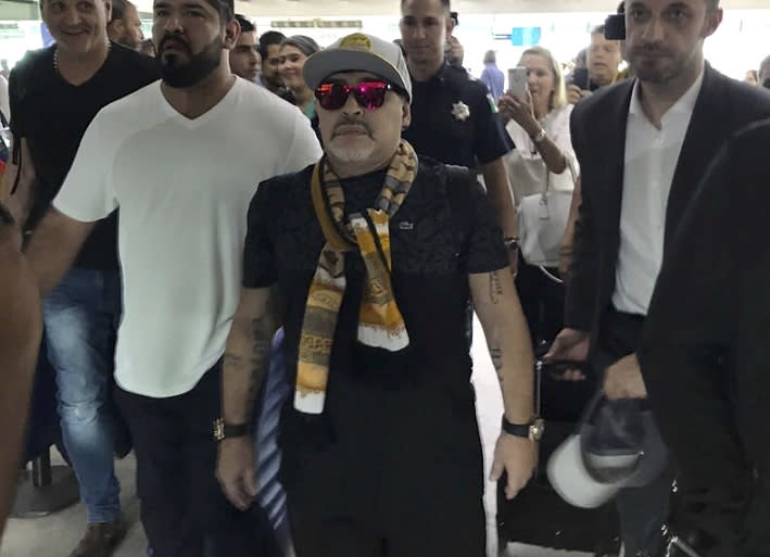 In this handout photo provided by Prensa Club Dorados de Sinaloa, Argentine soccer legend Diego Maradona walks through the airport in Culiacan, Mexico, Saturday, Sept. 8, 2018. Maradona arrived in northern Mexico Saturday afternoon, to begin his new job as head coach of the second-tier Mexican soccer club Dorados of Sinaloa. (Prensa Club Dorados de Sinaloa via AP)