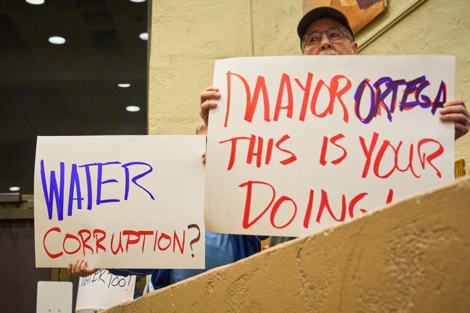 Residents of the Rio Verde Foothills hold signs in protest of Scottsdale cutting off their water at the start of the year during a Scottsdale city council meeting at the Scottsdale Civic Center on Tuesday, Jan. 10, 2023.
