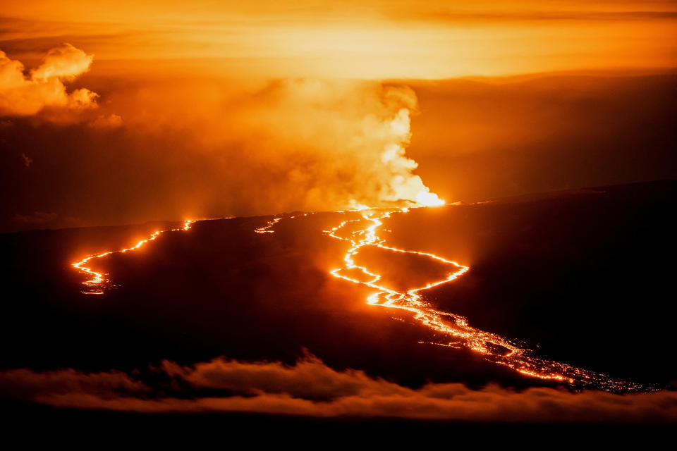 Lava fountains and flows illuminate the area during the Mauna Loa volcano eruption