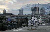 An helicopter stands outside the CHU Nord hospital in Grenoble, French Alps, where retired seven-times Formula One world champion Michael Schumacher is reported to be hospitalized after a ski accident, December 29, 2013. Schumacher suffered a head injury in a fall while skiing off-piste in the French Alps resort of Meribel on Sunday, an official said. The 44-year-old German was wearing a helmet and was conscious while being transported to a local hospital before later being transferred to to a better-equipped medical unit in Grenoble for further examinations. (REUTERS/Robert Pratta)