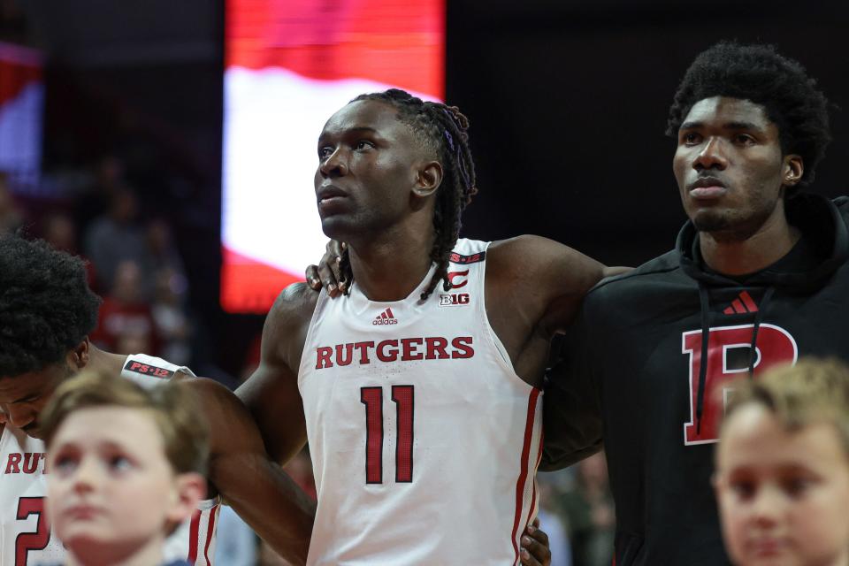 Rutgers Scarlet Knights center Clifford Omoruyi (11) stands with teammates during the national anthem