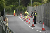 FILE - In this Wednesday, June 9, 2021 file photo, police officers stand guard outside a security gate around Tregenna Castle in Carbis Bay, Cornwall, England. Towering steel fences and masses of police have transformed the Cornish seaside as leaders of the Group of Seven wealthy democracies descent for a summit near St. Ives in Cornwall, a popular holiday destination. A huge frigate dominates the coastline, armed soldiers guard the main sites and some 5,000 extra police officers have been deployed to the area. (AP Photo/Jon Super, File)