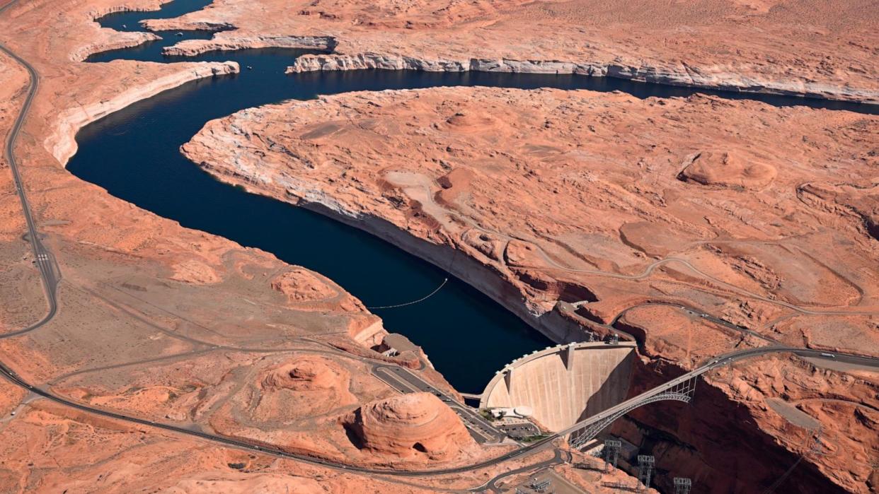 PHOTO: Glen Canyon Dam holds back Colorado River water to create Lake Powell, April 15, 2023, in Lake Page, Ariz. (RJ Sangosti/MediaNews Group/The Denver Post via Getty Images)