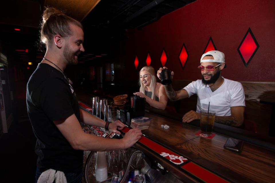 In this Journal Sentinel file photo, bartender Gary Tiffany hangs out with clients Jon Micheals and Rebecca Poppe at Elwood's Liquor & Tap at 1111 N. Water St. in Milwaukee.