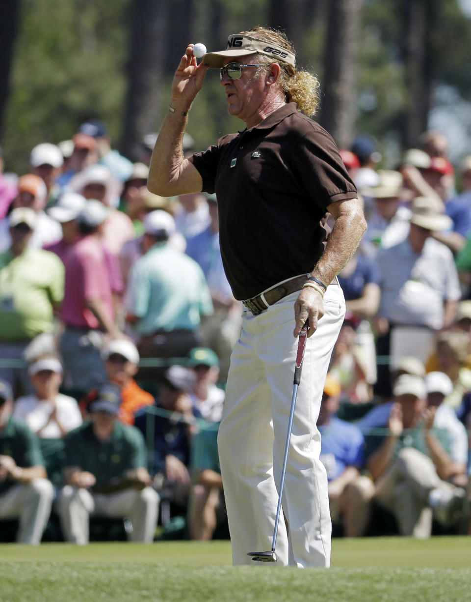 Miguel Angel Jimenez, of Spain, tips his cap after putting on the sixth hole during the third round of the Masters golf tournament Saturday, April 12, 2014, in Augusta, Ga. (AP Photo/Darron Cummings)