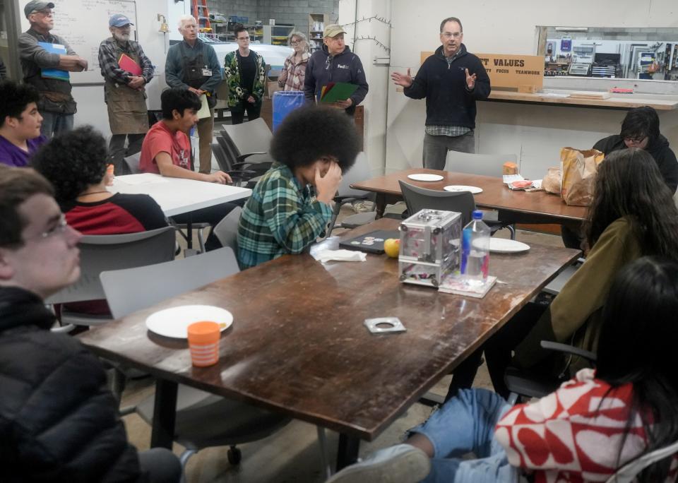 Patrick McBriarty speaks to students after they ate pizza and prepare to build a boat Monday, Feb. 5, 2024, at All Hands Boatworks in Milwaukee.