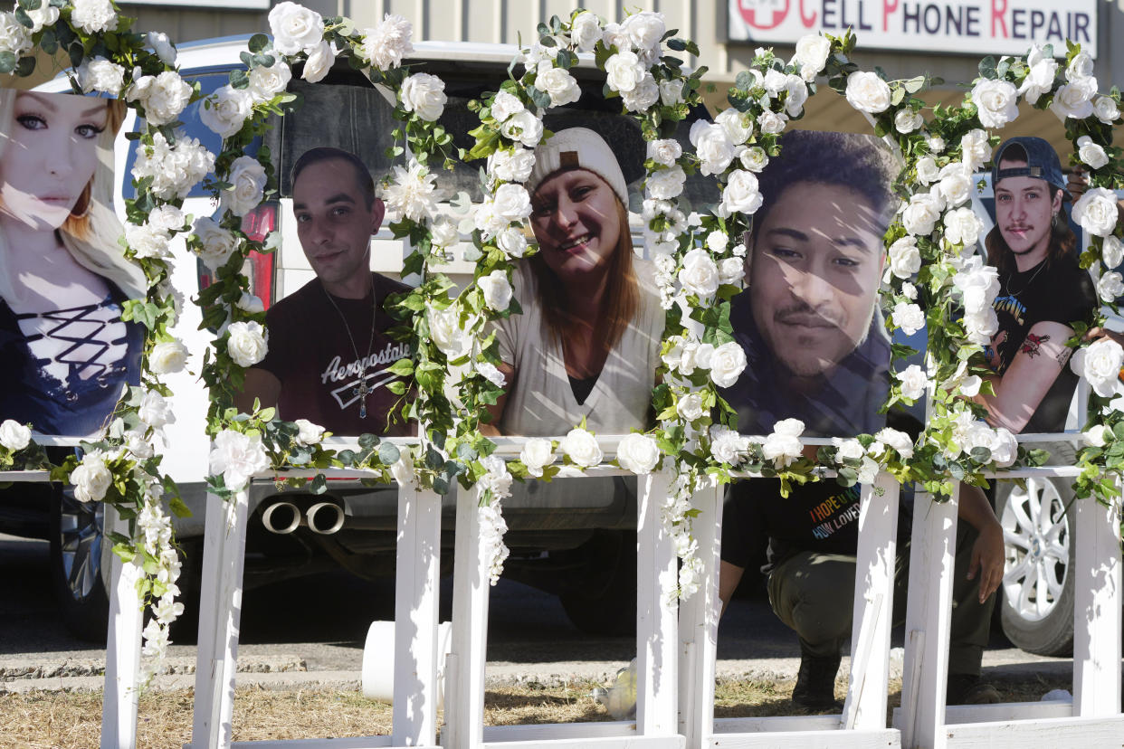 FILE - Photographs of victims of a weekend mass shooting at a nearby gay nightclub are on display at a memorial on Tuesday, Nov. 22, 2022, in Colorado Springs, Colo. A year and a half before the Colorado Springs gay nightclub shooting that left five dead, the alleged shooter was accused of threatening to kill his grandparents if they stood in the way of his plans to become “the next mass killer.” (AP Photo/David Zalubowski, File)