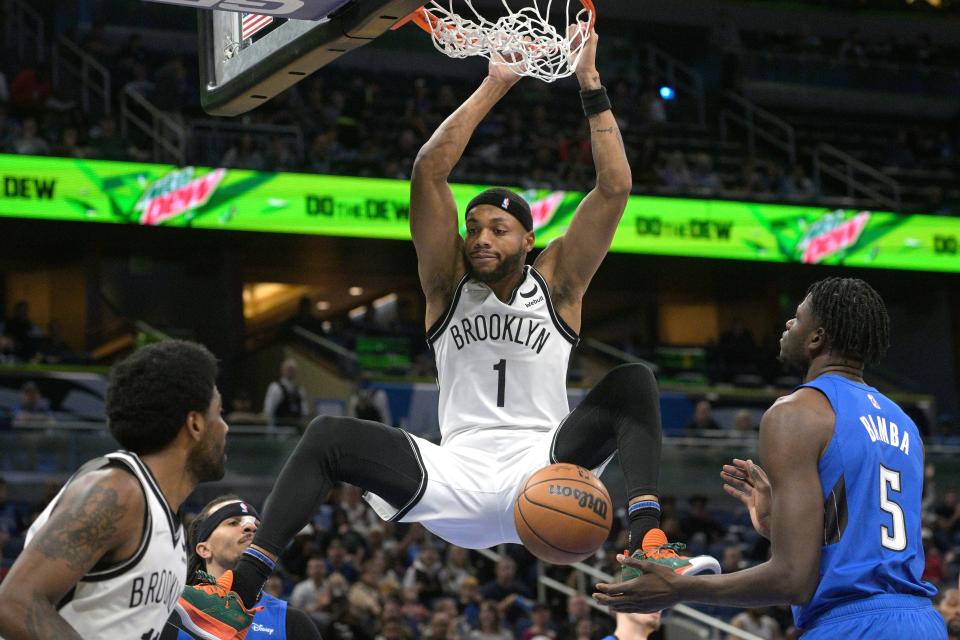 Brooklyn Nets forward Bruce Brown (1) dunks in front of Orlando Magic center Mo Bamba (5) during the first half of an NBA basketball game Tuesday, March 15, 2022, in Orlando, Fla. (AP Photo/Phelan M. Ebenhack)