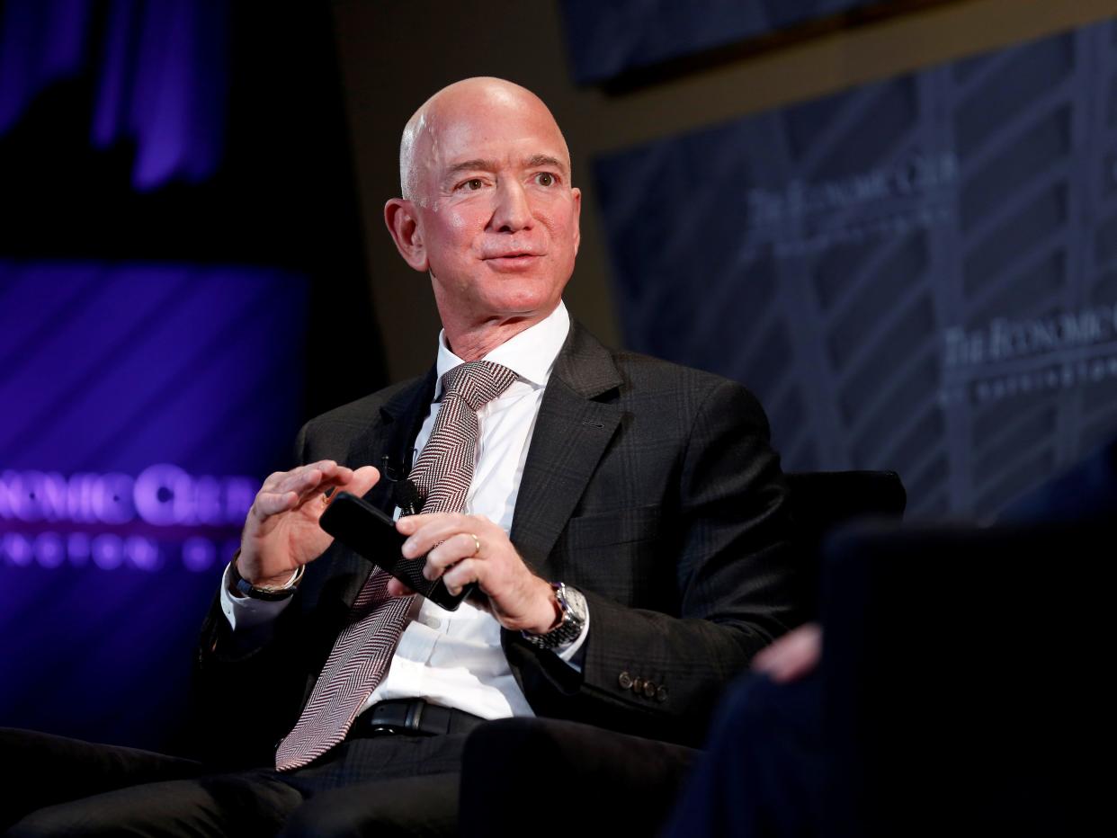 FILE PHOTO: Jeff Bezos, president and CEO of Amazon and owner of The Washington Post, speaks at the Economic Club of Washington DC's "Milestone Celebration Dinner" in Washington, U.S., September 13, 2018. REUTERS/Joshua Roberts/File Photo