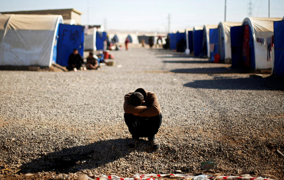 Displaced Iraqi man, who fled the Islamic State stronghold of Mosul, rests at Khazer camp