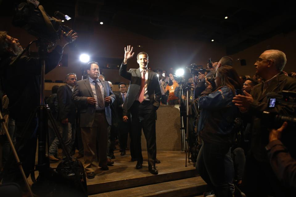 Venezuela's opposition leader and self-proclaimed interim president Juan Guaidó waves as he arrives to present details of his "Plan Pais" or Plans for the Country, to members of the agro-food sector, in Caracas, Venezuela, Wednesday, June 19, 2019. The United Nations’ top human rights official Michelle Bachelet is set to arrive in Venezuela on Wednesday and is expected to meet with Guaidó and Venezuelan President Nicolas Maduro — two men locked in a power struggle for control of the crisis-wracked nation. (AP Photo/Ariana Cubillos)