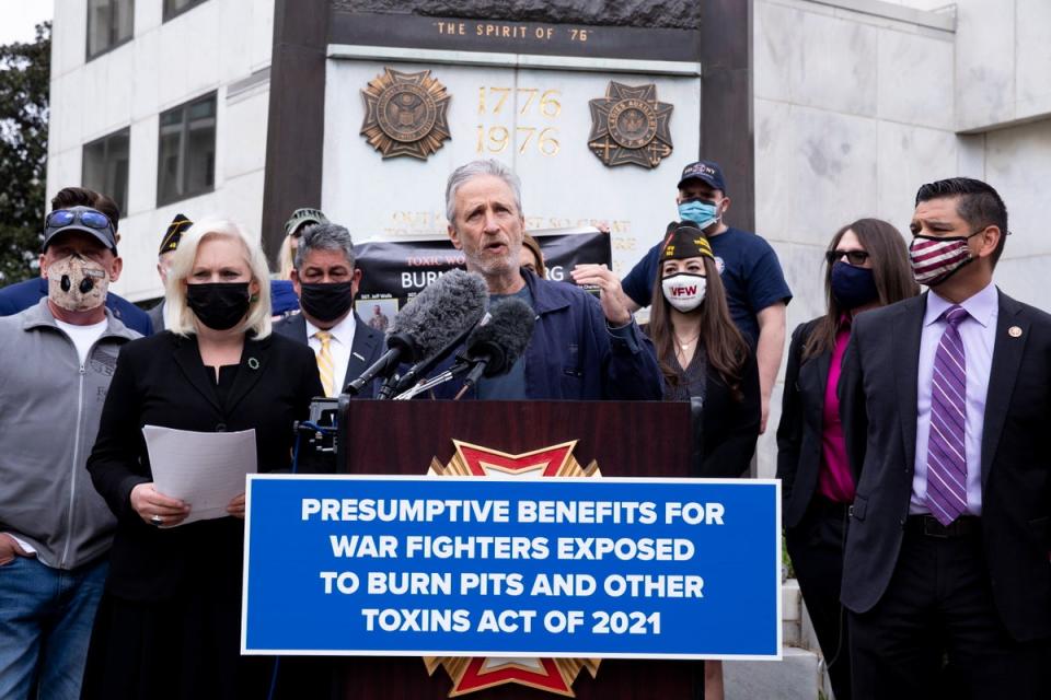 Jon Stewart speaks beside Democratic Senator from New York Kirsten Gillibrand about burn pits on Capitol Hill in April 2021 (EPA)