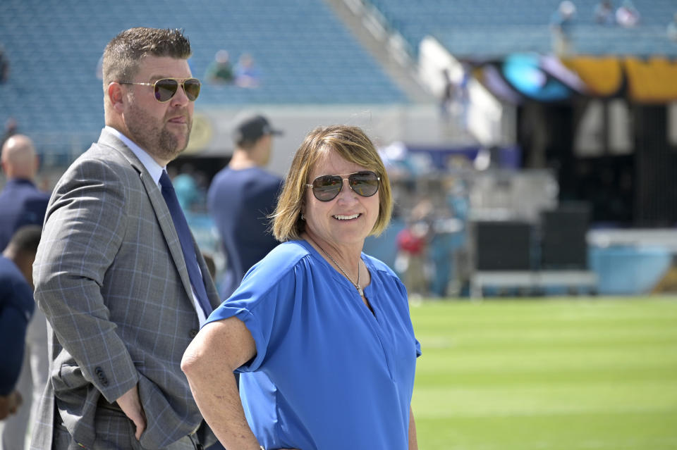 FILE - Tennessee Titans owner Amy Adams Strunk, right, and general manager Jon Robinson watch players warm up before an NFL football game against the Jacksonville Jaguars, Sunday, Oct. 10, 2021, in Jacksonville, Fla. Amy Adams Strunk has very high standards for her Titans. Combined with the millions and millions she's investing, she also isn't afraid of making big moves chasing the Lombardi Trophy that eluded her late father. Strunk fired general manager Jon Robinson on Tuesday, Dec. 6, 2022, in the midst of his seventh season with the Titans off to a 7-5 start. (AP Photo/Phelan M. Ebenhack, File)