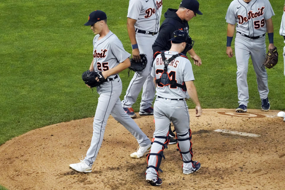 Detroit Tigers pitcher Matt Manning, left, heads for the dugout after he was pulled in the sixth inning of a baseball game against the Minnesota Twins, Friday, July 9, 2021, in Minneapolis. (AP Photo/Jim Mone)