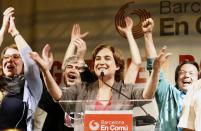 Leader of 'Barcelona en Comu' (Barcelona in Common) party and candidate for mayor of Barcelona Ada Colau (C) celebrates during a press conference following the results in Spain's municipal and regional elections in Barcelona on May 24, 2015