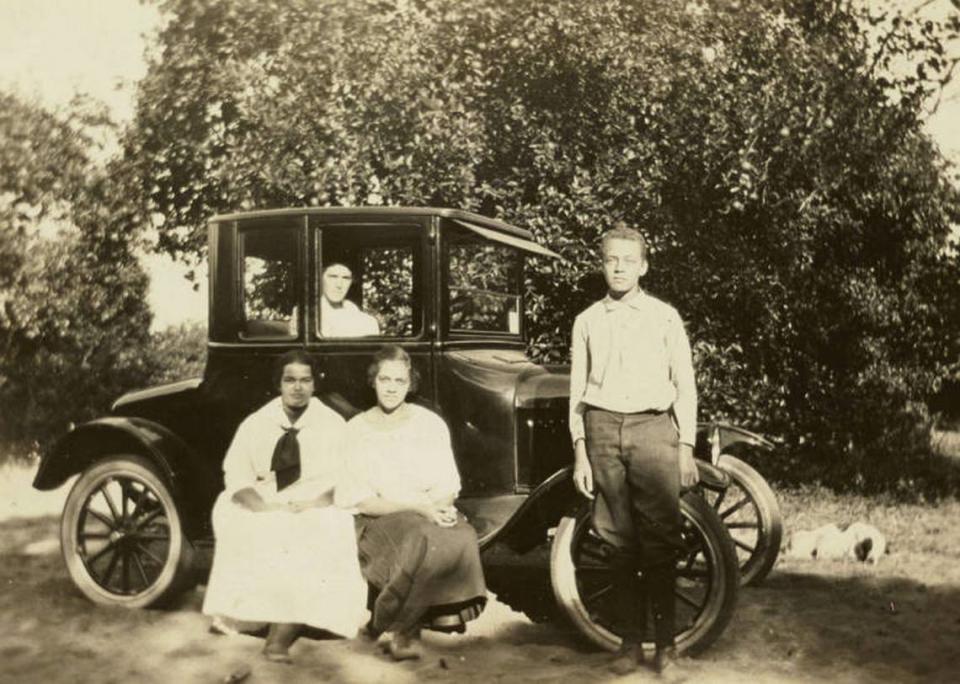 A family on their way to a Juneteenth celebration in the 1910s posed next to their Model T Ford.