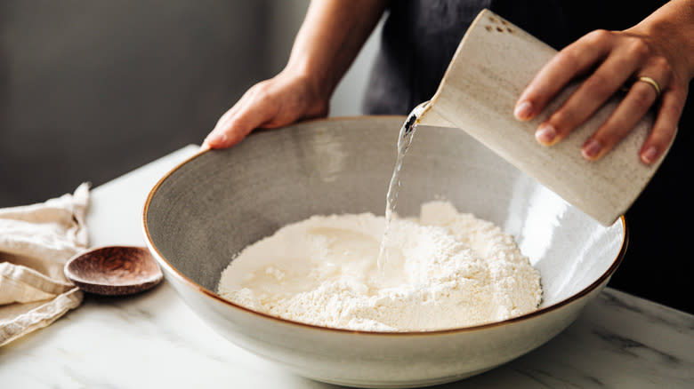 mixing water and flour