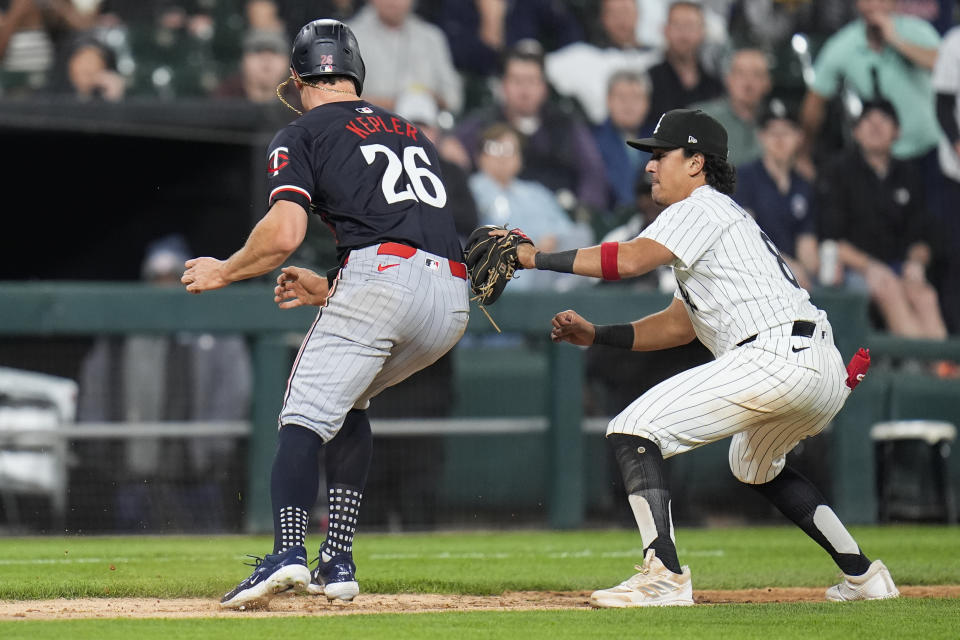 Minnesota Twins right fielder Max Kepler, left, gets caught between bases by Chicago White Sox catcher Martín Maldonado and is tagged out by third baseman Nicky Lopez during the sixth inning of a baseball game Tuesday, April 30, 2024, in Chicago. (AP Photo/Erin Hooley)