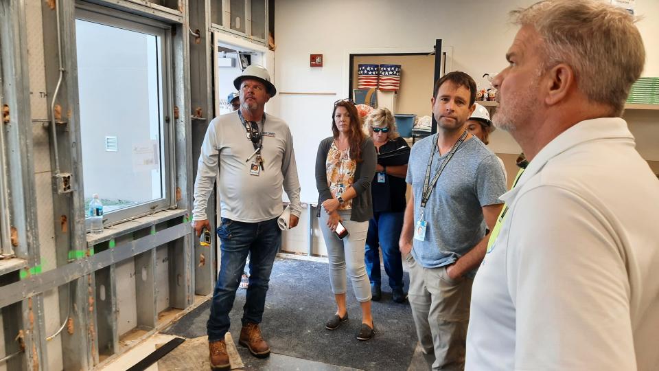 Sarasota Superintendent Brennan Asplen and district COO Jody Dumas assess hurricane damage with district contractors at Heron Creek Middle School in North Port.