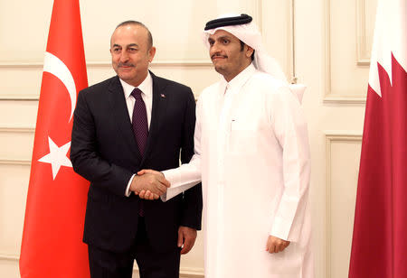 Qatari Foreign Minister Sheikh Mohammed bin Abdulrahman bin Jassim Al-Thani shakes hand with Turkish Foreign Minister Mevlut Cavusoglu during their meeting in Doha, Qatar November 1, 2018. REUTERS/Naseem Zeitoon