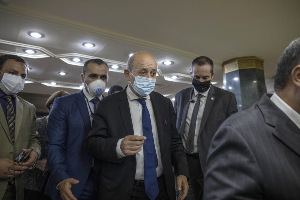 French Foreign Minister Jean-Yves Le Drian center leaves after a closed meeting with Muslim Grand Imam, Sheikh Ahmed el-Tayeb, at the headquarters of Al Azhar, in Cairo, Egypt, Sunday, Nov. 8, 2020. Le Drian visited Cairo on Sunday to meet with political and religious leaders in an effort to calm tensions and misunderstandings with the Arab and Muslim world following anti-French protests and three Islamic extremist attacks on France. (AP Photo/Nariman El-Mofty)