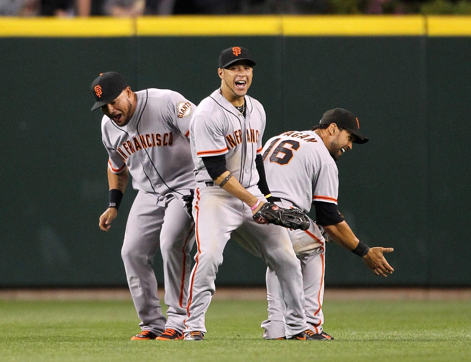 SEATTLE, WA - JUNE 15: L to R: Melky Cabrera #53, Gregor Blanco #7, and Angel Pagan #16 of the San Francisco Giants celebrate after defeating the Seattle Mariners 4-2 at Safeco Field on June 15, 2012 in Seattle, Washington. (Photo by Otto Greule Jr/Getty Images)