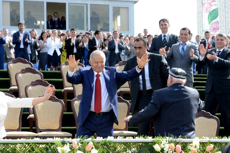 Uzbekistan's President Islam Karimov (C) dances during a state celebration of the Nowruz holiday in Tashkent, Uzbekistan on March 21, 2015