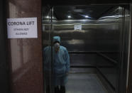 A lift operator protect himself with mask inside special lift for people who returned from China are under observation at the Government Gandhi Hospital in Hyderabad.