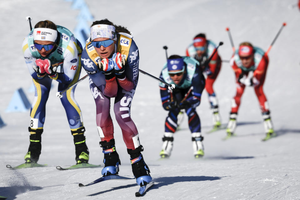 Jessie Diggins, center, of the United States, leads the pack as she skis during the women's 15km Mass Start freestyle World Cup cross country skiing event in Canmore, Alberta, Friday, Feb. 9, 2024. (Jeff McIntosh/The Canadian Press via AP)